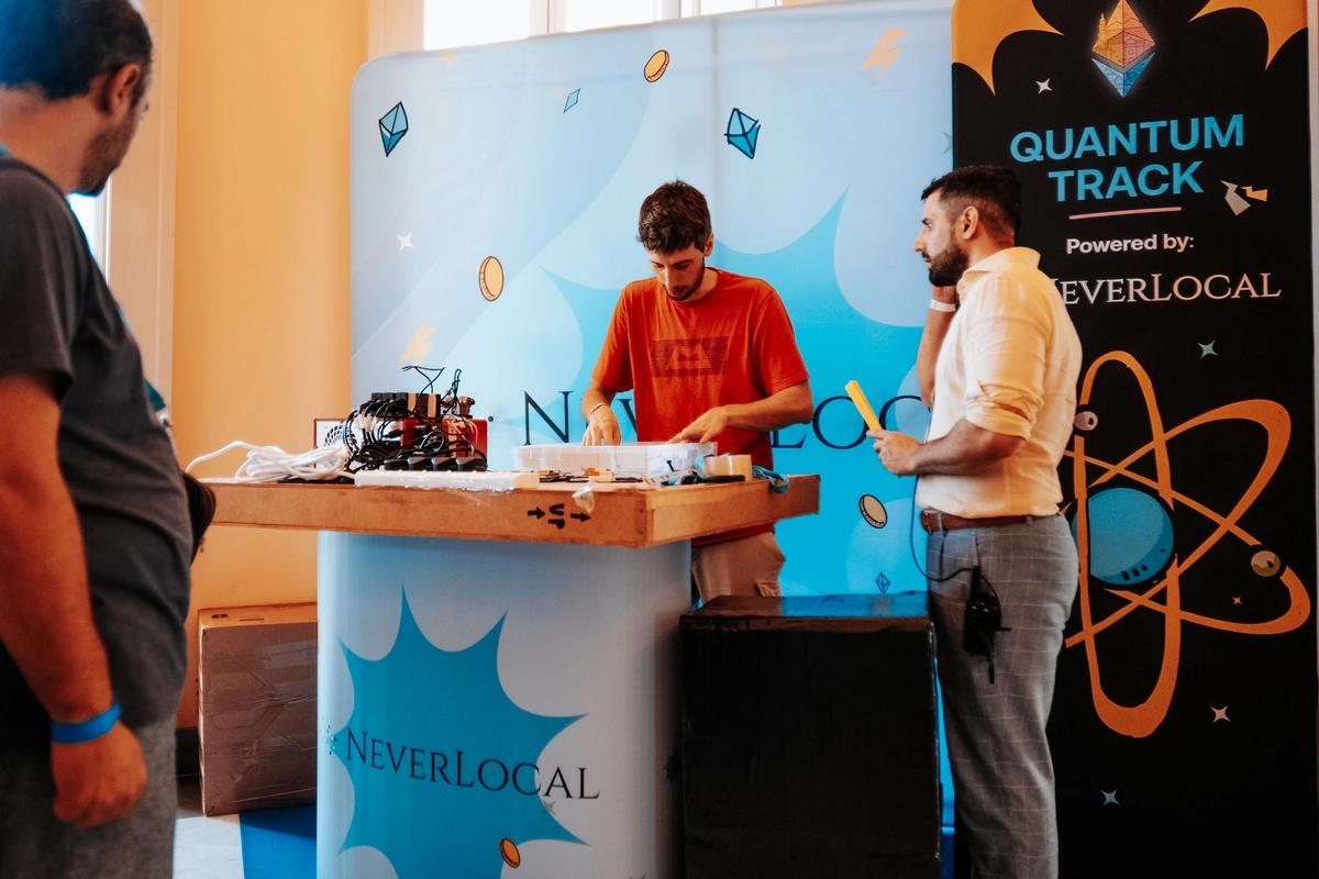 Fabrizio and Stefano showcasing equipment at the NeverLocal Stand during NapulETH.